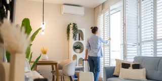 Renter with suitcase in a bright apartment learning how to get the best deal on an apartment.