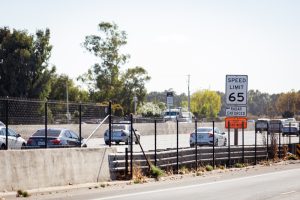 Speed limit sign along a roadway, highlighting what to do after a speeding ticket and the importance of following traffic laws.