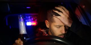 Driver sitting behind the wheel after a DUI stop, illustrating the emotional and legal challenges of life after a DUI.