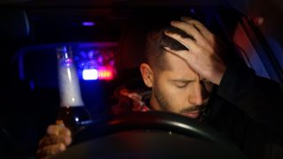 Driver sitting behind the wheel after a DUI stop, illustrating the emotional and legal challenges of life after a DUI.