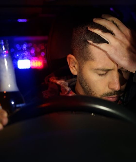 Driver sitting behind the wheel after a DUI stop, illustrating the emotional and legal challenges of life after a DUI.