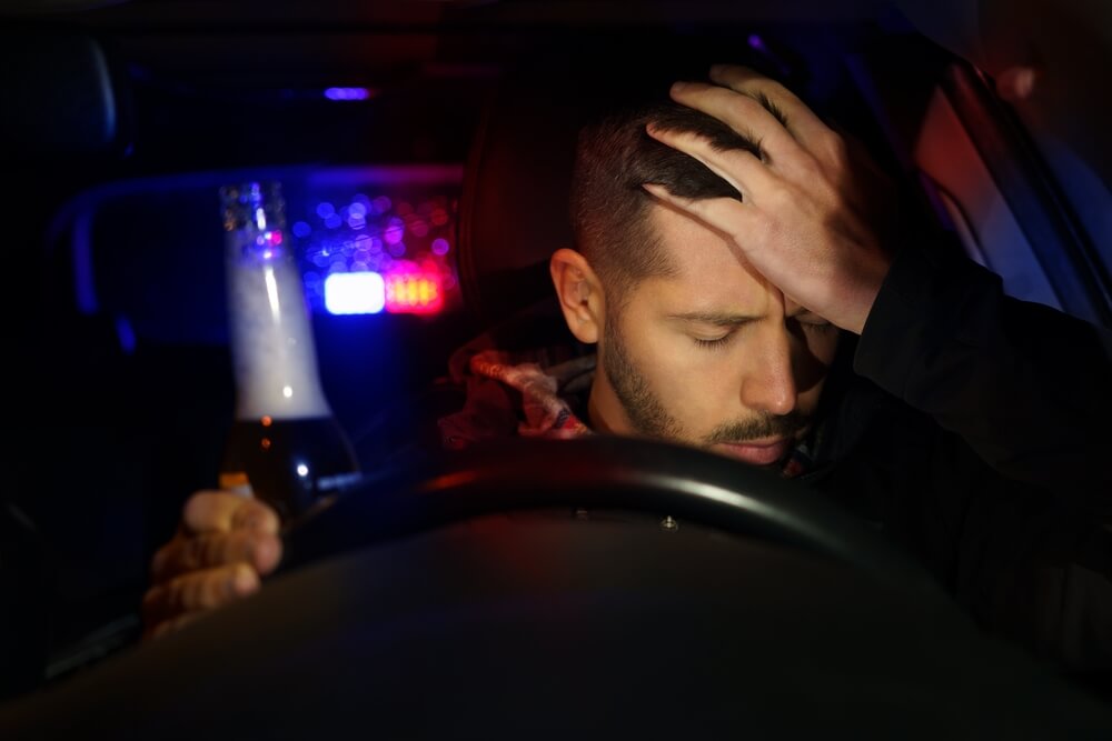 Driver sitting behind the wheel after a DUI stop, illustrating the emotional and legal challenges of life after a DUI.