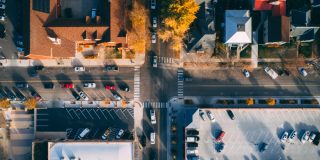 Aerial view of a busy 4-way stop sign intersection, rules of the road, how to handle a 4-way stop.