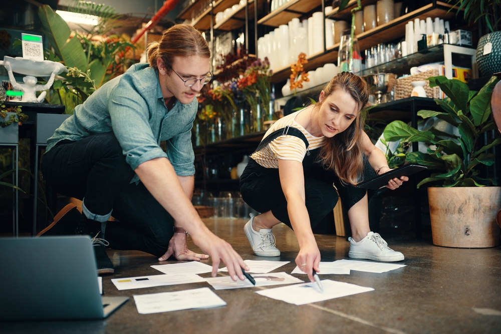 Business partners go over paperwork and insurance documents for their small business.