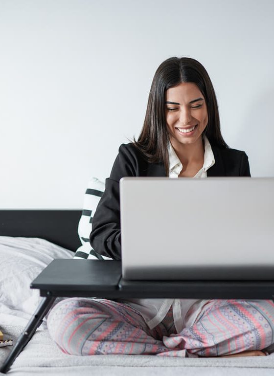 Beautiful young woman working from home with computer laptop - Home, office or freelancer insurance concept.