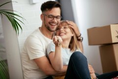 Boyfriend and girlfriend are moving in a apartment. Boyfriend and girlfriend are unpacking their belongings, while checking to make sure they have renters insurance on everything.