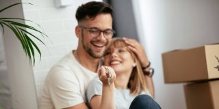 Boyfriend and girlfriend are moving in a apartment. Boyfriend and girlfriend are unpacking their belongings, while checking to make sure they have renters insurance on everything.