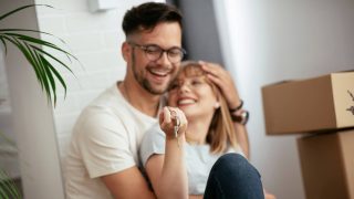 Boyfriend and girlfriend are moving in a apartment. Boyfriend and girlfriend are unpacking their belongings, while checking to make sure they have renters insurance on everything.
