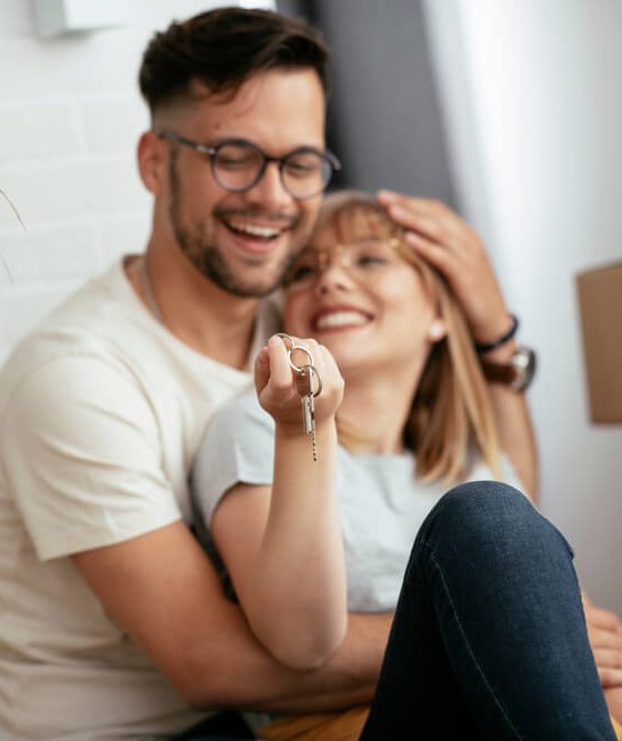 Boyfriend and girlfriend are moving in a apartment. Boyfriend and girlfriend are unpacking their belongings, while checking to make sure they have renters insurance on everything.