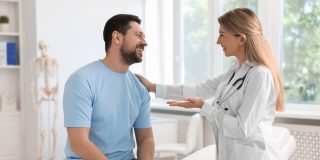 Doctor consulting with a patient in a hospital setting, representing medical care options available through Covered California.