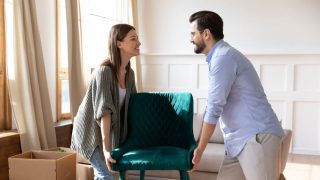 Happy young couple settling into their new home, protected by renters insurance.