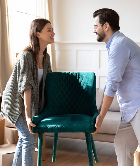Happy young couple settling into their new home, protected by renters insurance.