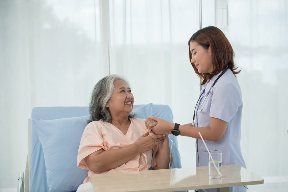 An elderly woman at the doctor. Parents looking at what needs to change for Covered California 