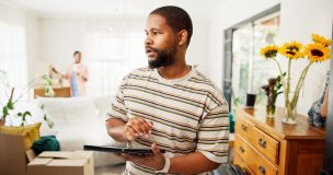 Thinking, tablet and moving with black man in new home for relocation, furniture inventory and real estate. Boxes checklist, property investment and reflection with couple in living room for planning.