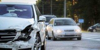 Damaged vehicle on the roadside after a hit and run accident, highlighting the importance of knowing what to do after a hit and run.