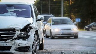 Damaged vehicle on the roadside after a hit and run accident, highlighting the importance of knowing what to do after a hit and run.