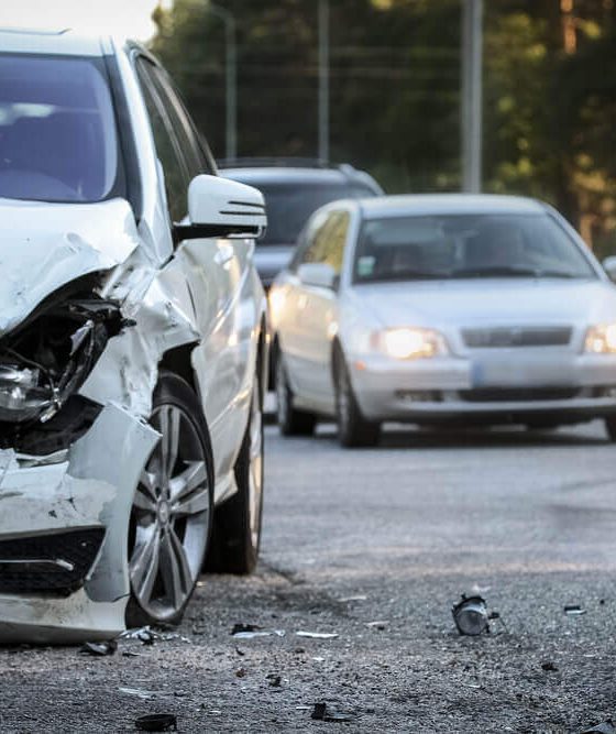Damaged vehicle on the roadside after a hit and run accident, highlighting the importance of knowing what to do after a hit and run.
