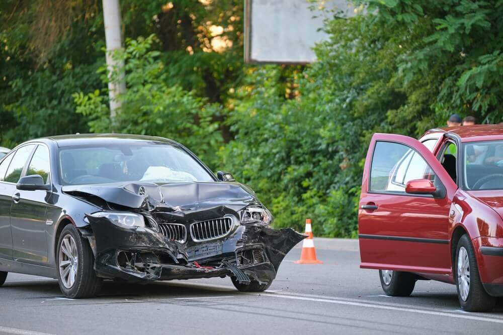 Two damaged vehicles involved in a collision, illustrating a situation where drivers need to know what to do after a hit and run.