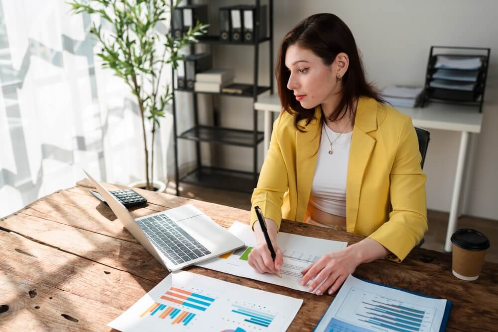 Business owner reviewing financial documents to evaluate home-based business insurance needs.