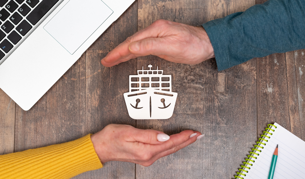 Hands protecting a boat symbol representing boat insurance coverage.