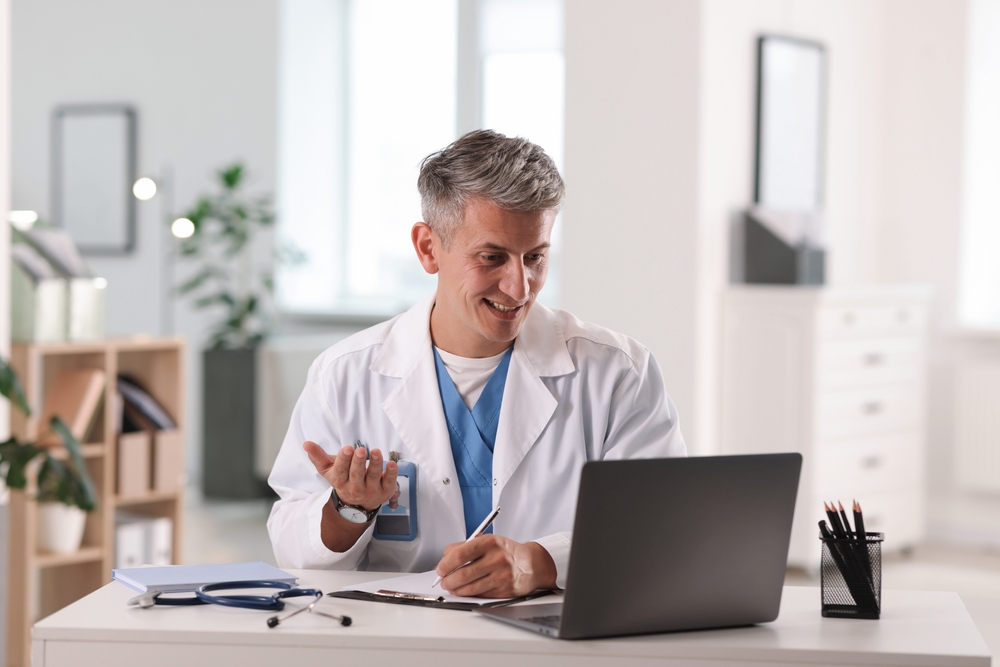 Doctor providing a telemedicine consultation from his office.