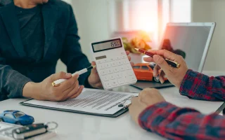 Car insurance agreement with car keys on table, cheap car insurance.
