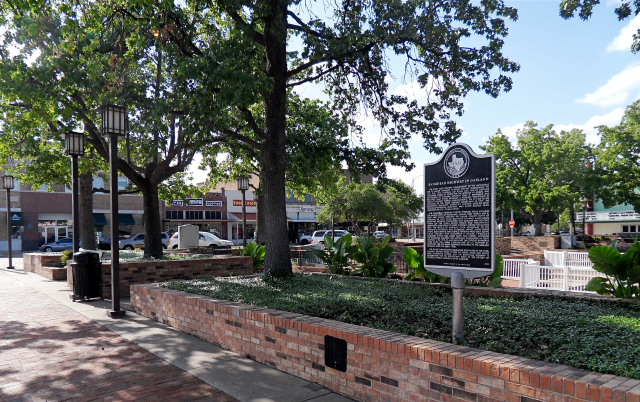 The historical part of downtown Garland, with historical marker, shops, and landscaping – Garland, cheap car insurance in Texas