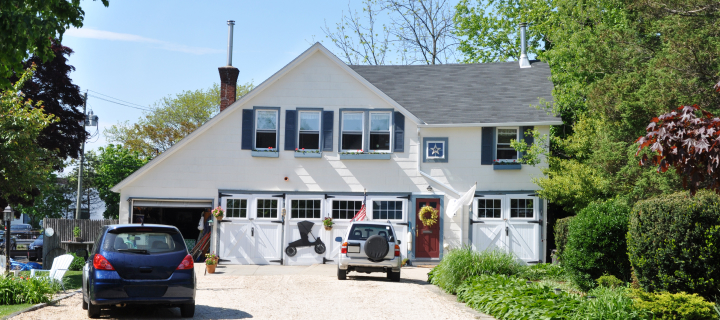Country Home with Two Cars in Driveway sunny blue sky day