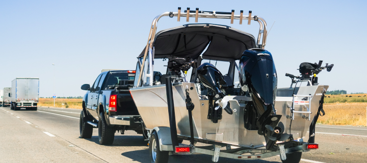 Pickup truck towing a boat on the interstate, California.
