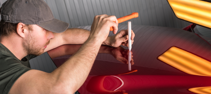 Removal of dents without painting. PDR technology for car body repair.