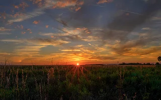 A brilliant sunset illuminates the dramatic sky at Kissimmee Prairie Preserve in Okeechobee, FL – Florida, cheap car insurance in Kissimmee