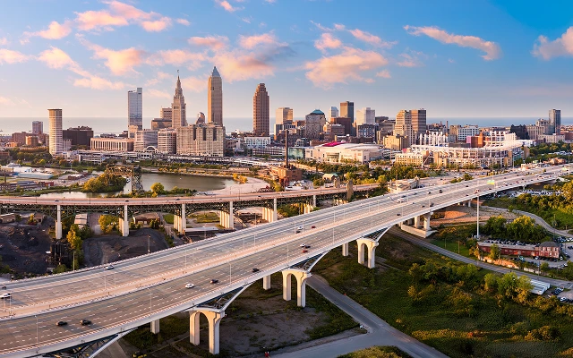 Aerial view of Cleveland, Ohio skyline and I90 interstate highway at sunset – Cleveland, cheap car insurance in Ohio