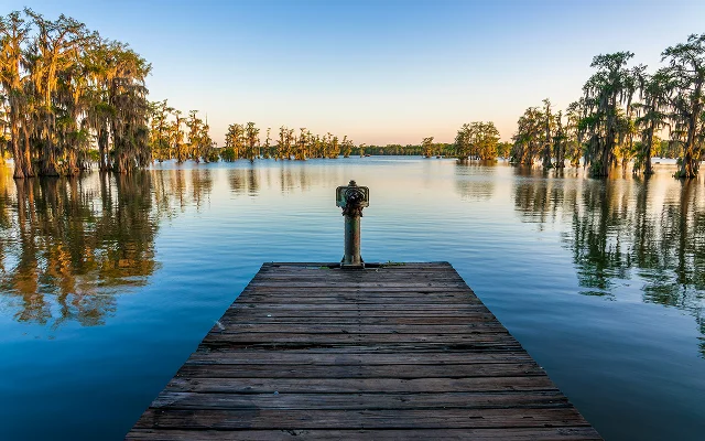 Fishing pier at Lake Martin, Cypress Island Preserve, Cypress swamp scenic landscape with reflections, Breaux Bridge near Lafayette, Louisiana. Cheap car insurance in LA.