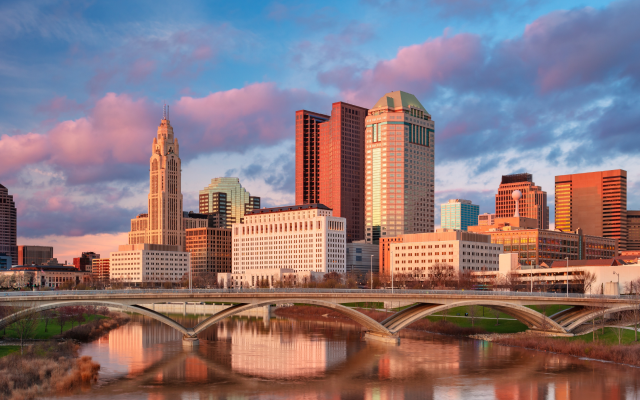 Downtown skyline with the reflection of the city in the Scioto River at spring sunset in Columbus, Ohio