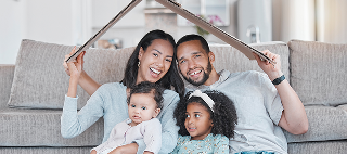 Happy family, new house and cardboard roof in living room.